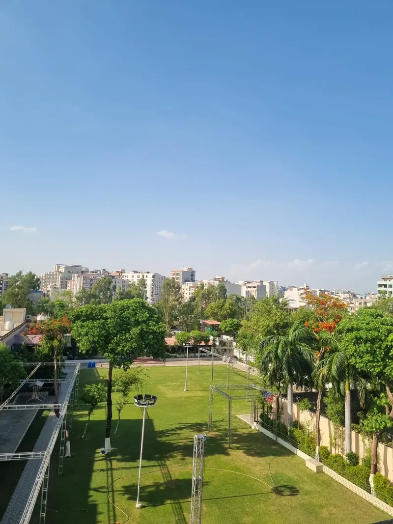 Green lawns and palm trees at the Sanjog garden